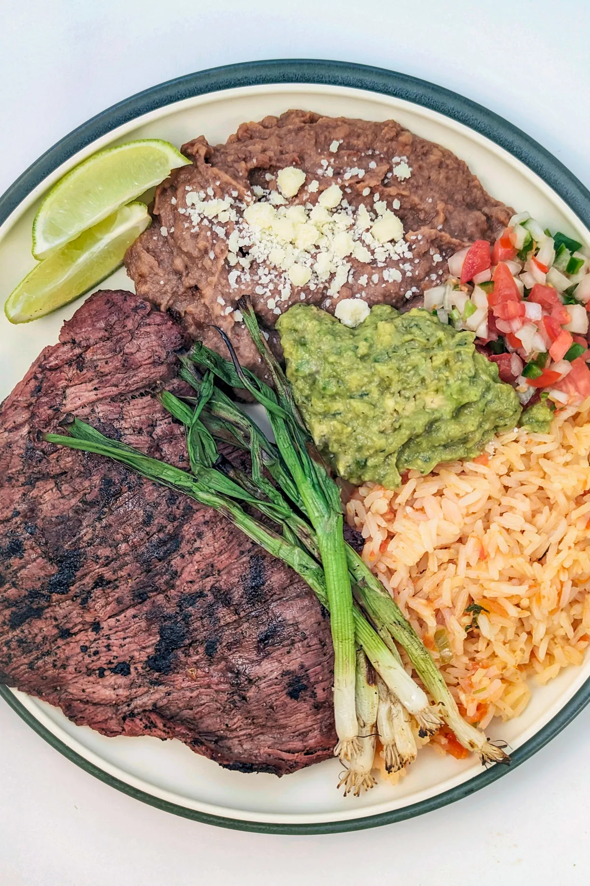 Carne asada platter with rice, beans, and pico de gallo