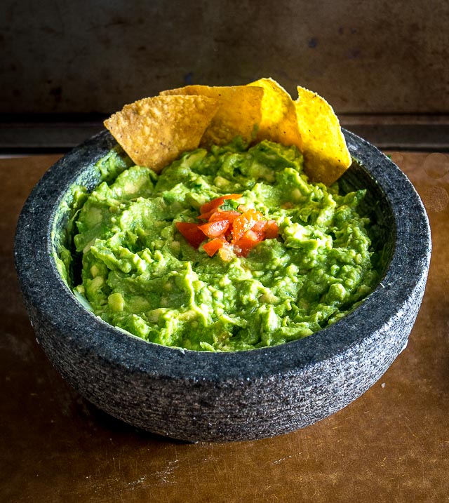 Fresh molcajete guacamole with warm tortilla chips