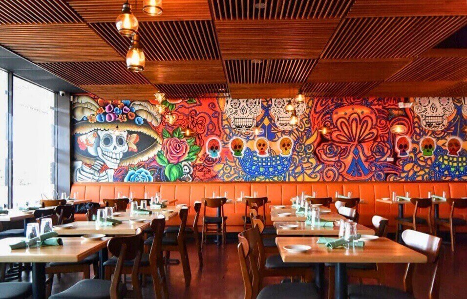Inside Casa Luna's main dining room with warm pendant lighting